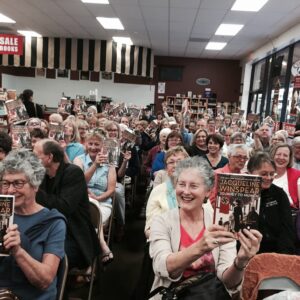 A large crowd cheers for favorite author Jacqueline Winspear