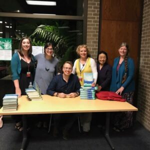 A group of booksellers surround the author Frederick Backman